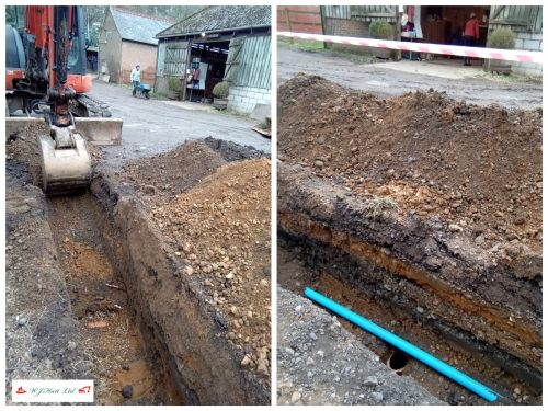 Excavating a trench through a farmyard to install replacement pipework 